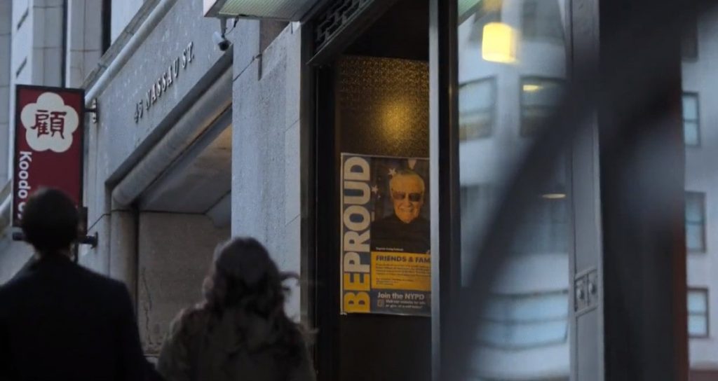 Scene from Netflix show featuring Stan Lee as an NYPD cop on a poster in New York City