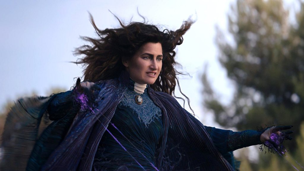 Kathryn Hahn in a dark blue cloak casting a spell in WandaVision