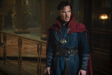 Doctor Strange in a blue and red outfit with a small wound on his face