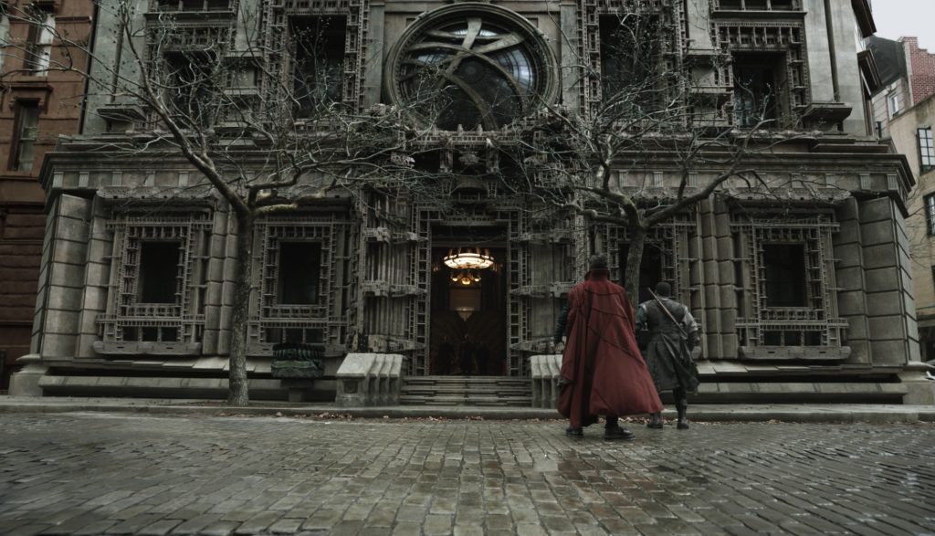 Dr. Strange stands in front of a large mansion in New York City