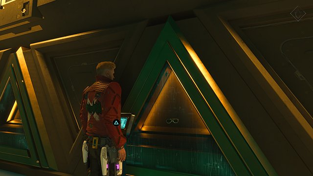 A screenshot of the Marvel's Guardians of the Galaxy video game in a dark room with a small pair of glasses in a green triangle case.