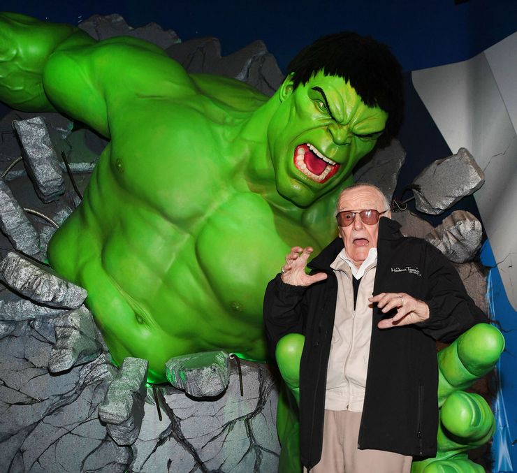 Stan Lee feigns being scared in the hands of Madame Tussauds Hulk wax figure.