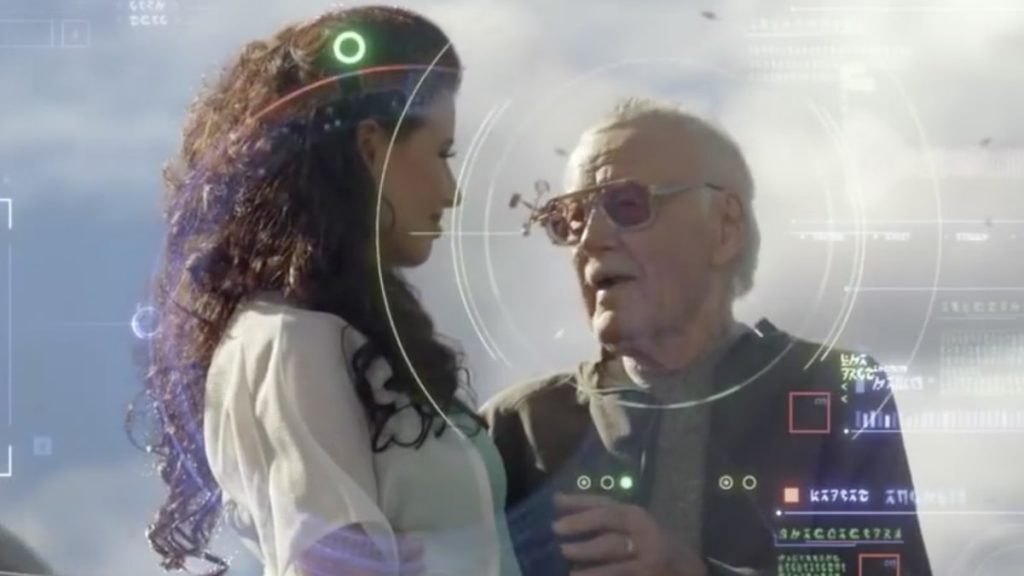 Stan Lee speaking to a woman in white