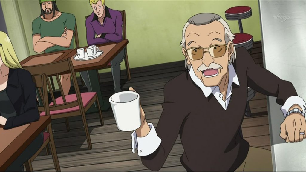 An animated version of Stan Lee with a brown sweater and gray and white hair holds a white coffee cup up.