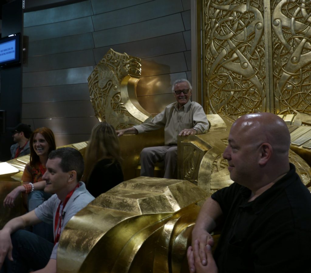 Stan Lee sitting and smiling on Odins throne at San Diego Comic Con