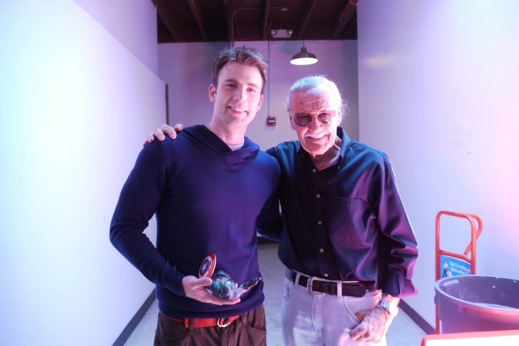 Stan Lee standing with his arm around Chris Evans backstage at San Diego Comic Con 